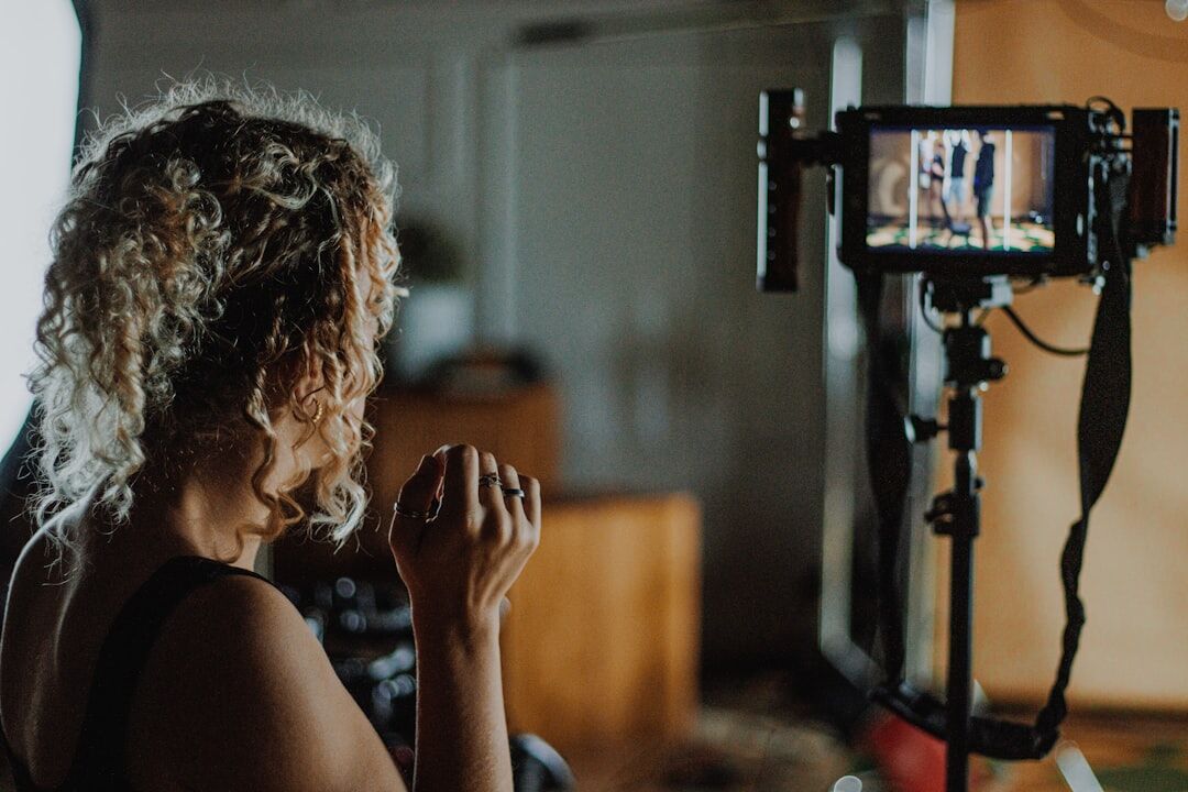 Young Belgian woman operating a professional video camera in a studio