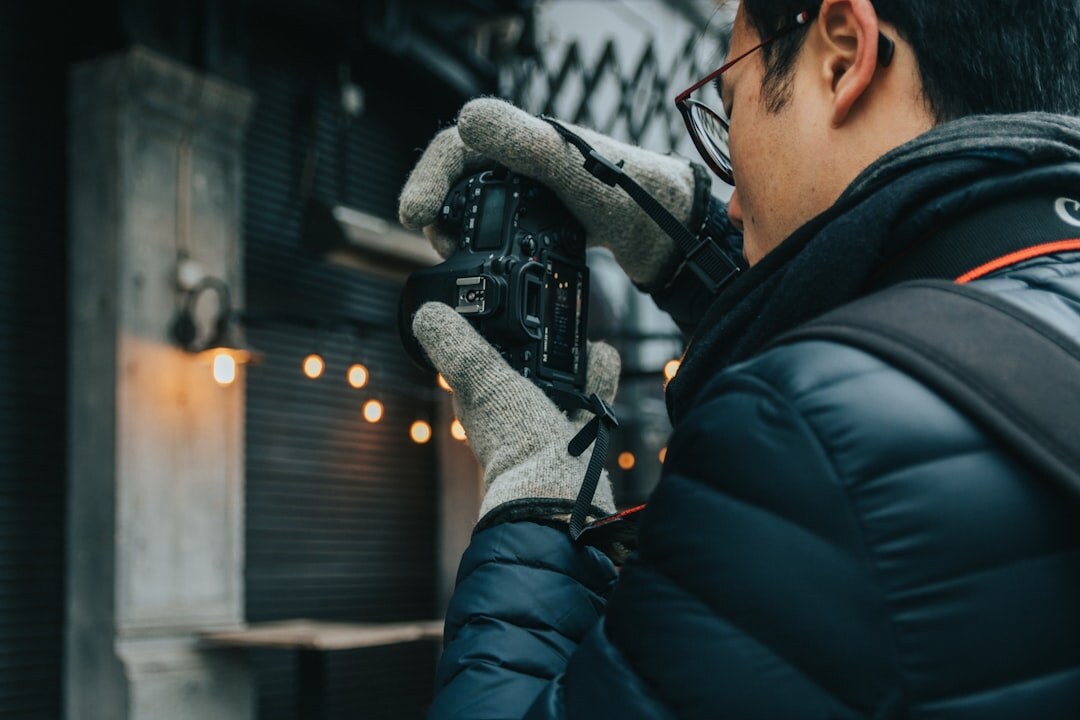 Belgian male videographer framing a shot with a camera